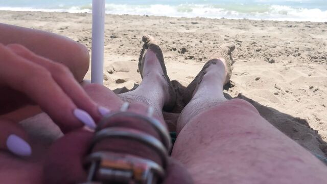 Teasing in chastity on the beach