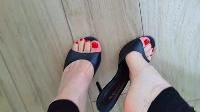Sexy feet in high heels mules