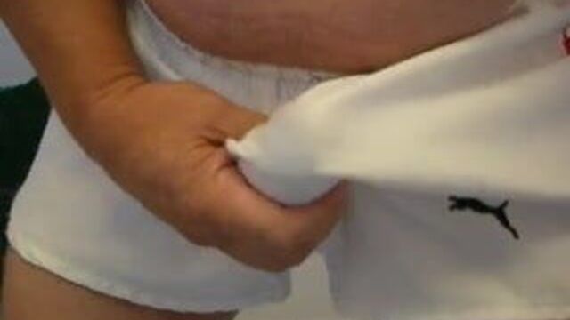 Wanking in white shiny Puma shorts