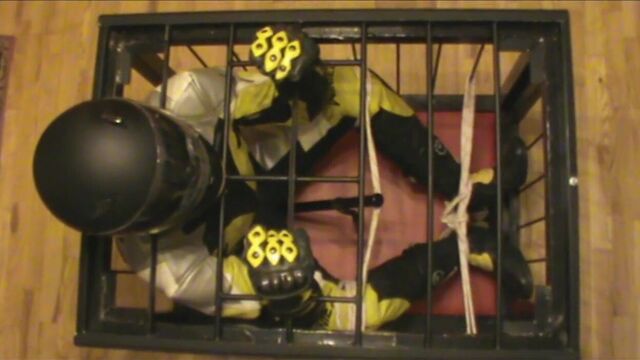 Caged bikerslave is restrained